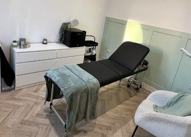 Flawless beauty room features a cozy treatment bed and modern decor in Lostock Hall, England, GB.