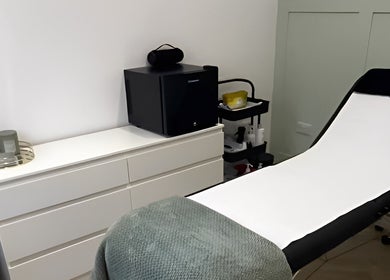Tranquil treatment room at Flawless, Lostock Hall, England, GB, featuring a modern white aesthetic.