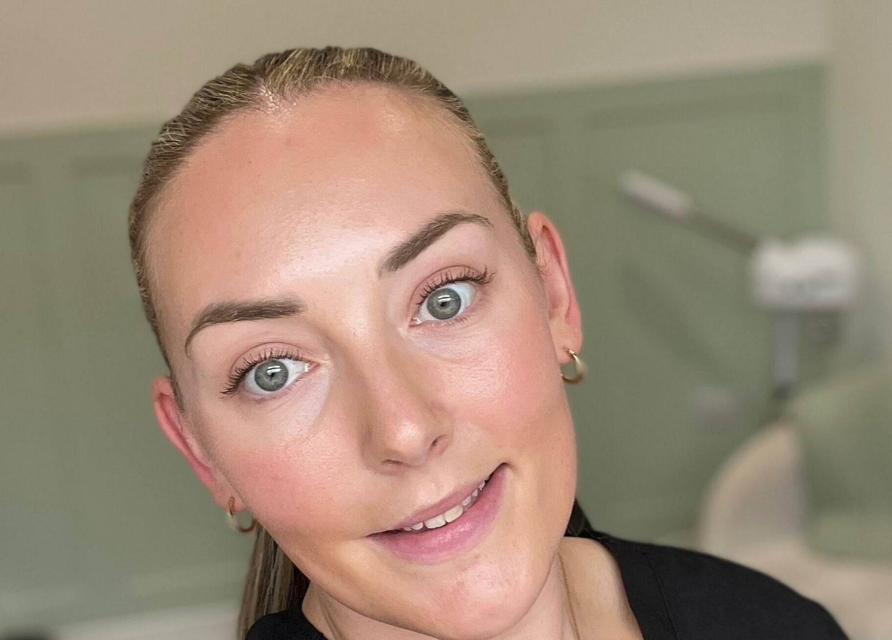 Smiling professional at Flawless, Lostock Hall, England, GB in a serene beauty setting.