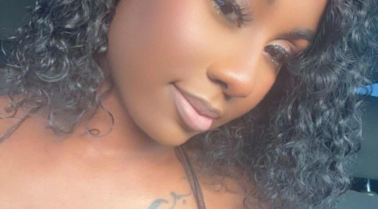Close-up of elegant makeup artistry by Faces by Jazz in Jacksonville, Florida, US, highlighting smooth skin and curls.