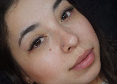 Close-up of a woman's face showcasing elegant eyelashes at Inkbeauty, Framingham, Massachusetts, US.