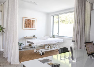 Calming massage room at The Deep Unwind in Woollahra, New South Wales, AU with fresh plants and serene decor.