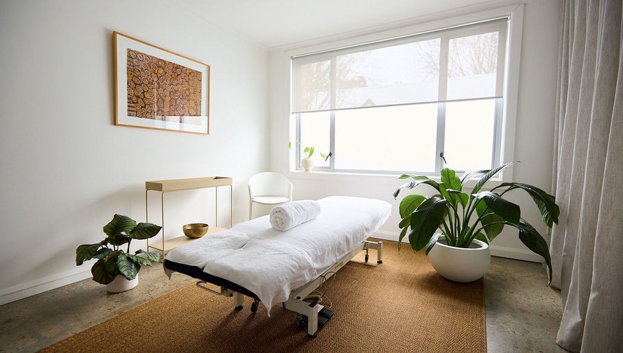 Calming treatment room at The Deep Unwind, Woollahra, New South Wales, AU with a massage table and plants.