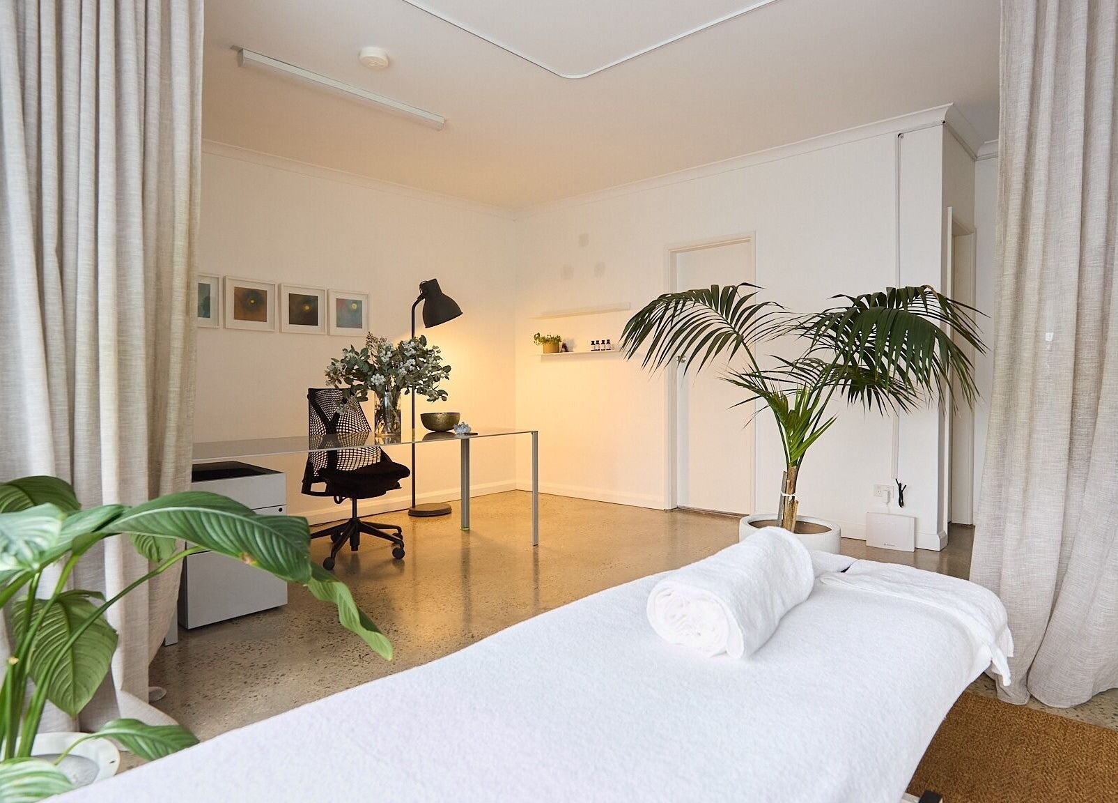 Relaxing treatment room at The Deep Unwind, Woollahra, New South Wales, AU with lush greenery and cozy lighting.
