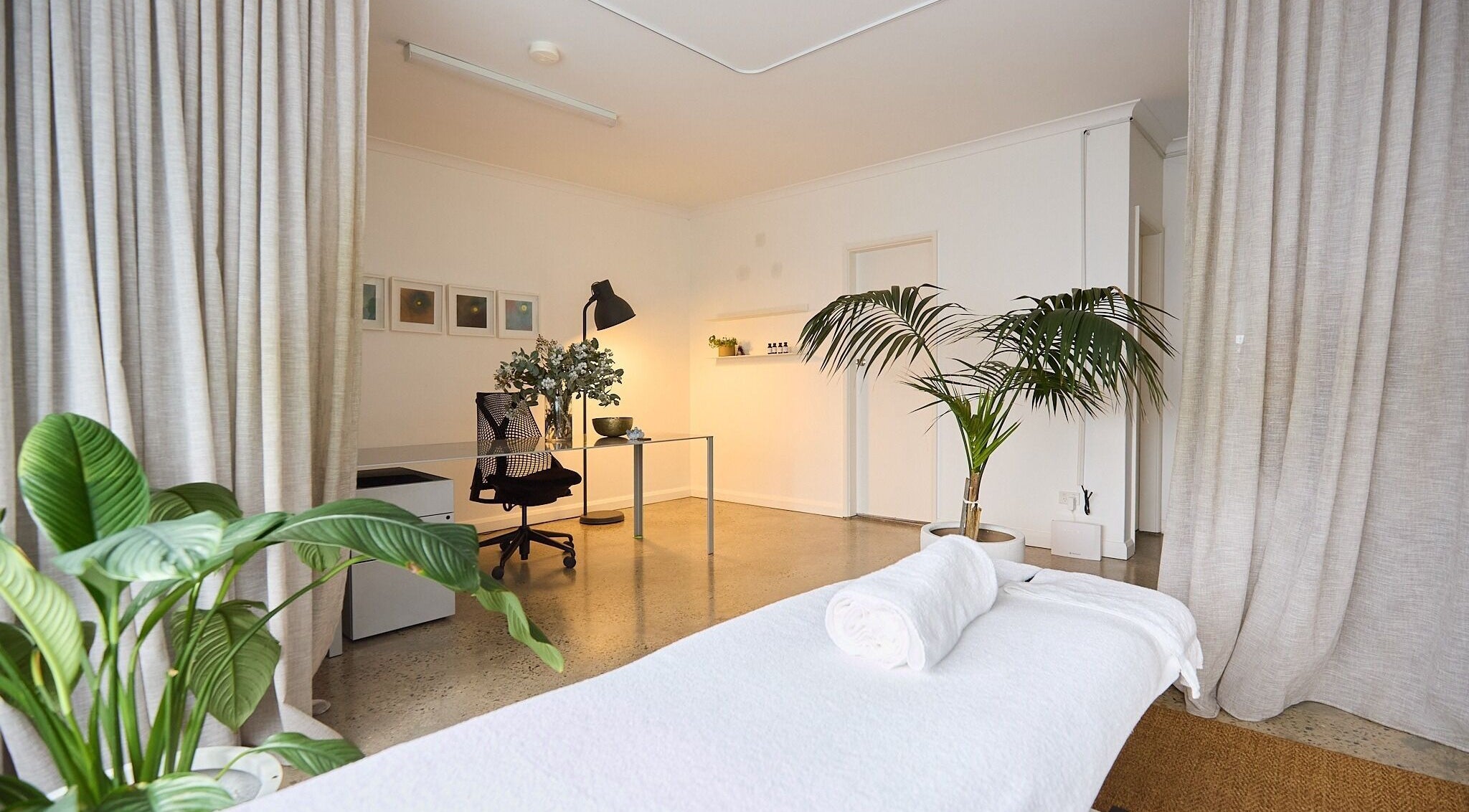 Relaxing treatment room at The Deep Unwind, Woollahra, New South Wales, AU with lush greenery and cozy lighting.