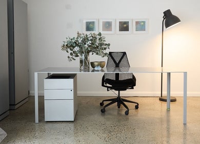 Minimalist office at The Deep Unwind, Woollahra, New South Wales, AU with chair and modern decor.