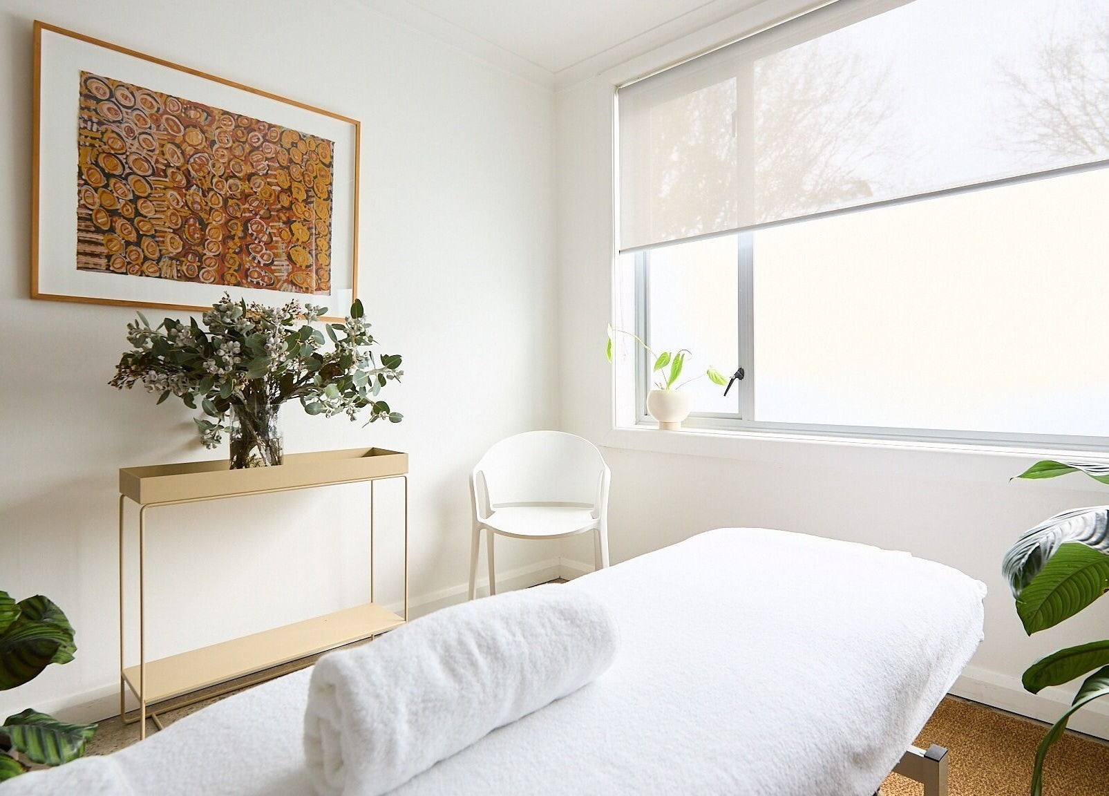 Tranquil treatment room at The Deep Unwind, Woollahra, New South Wales, AU with cozy decor and plant accents.
