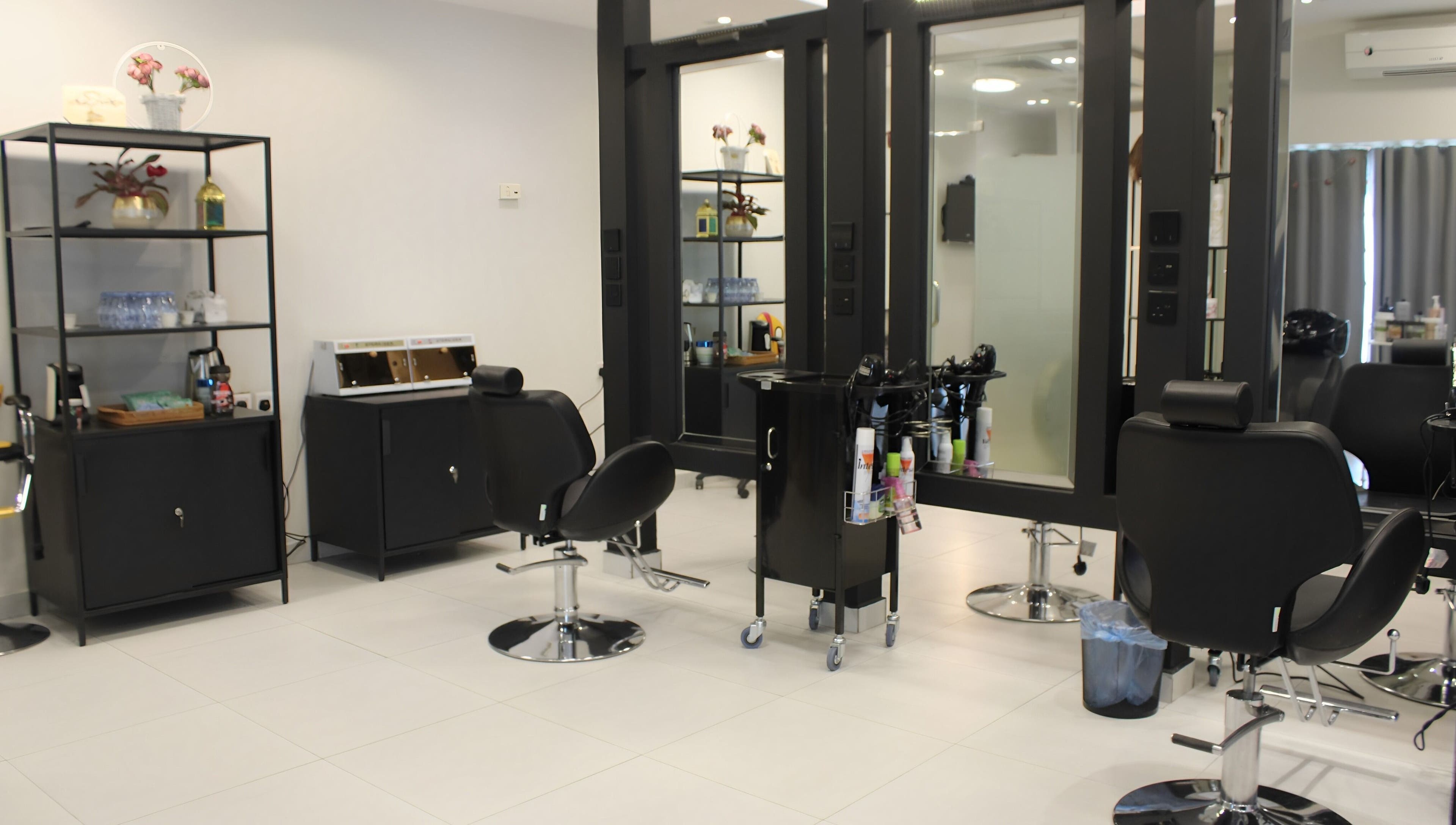 Modern interior of Aklel AlJamal Salon in Riyadh, Riyadh Province, SA showcasing sleek styling stations.