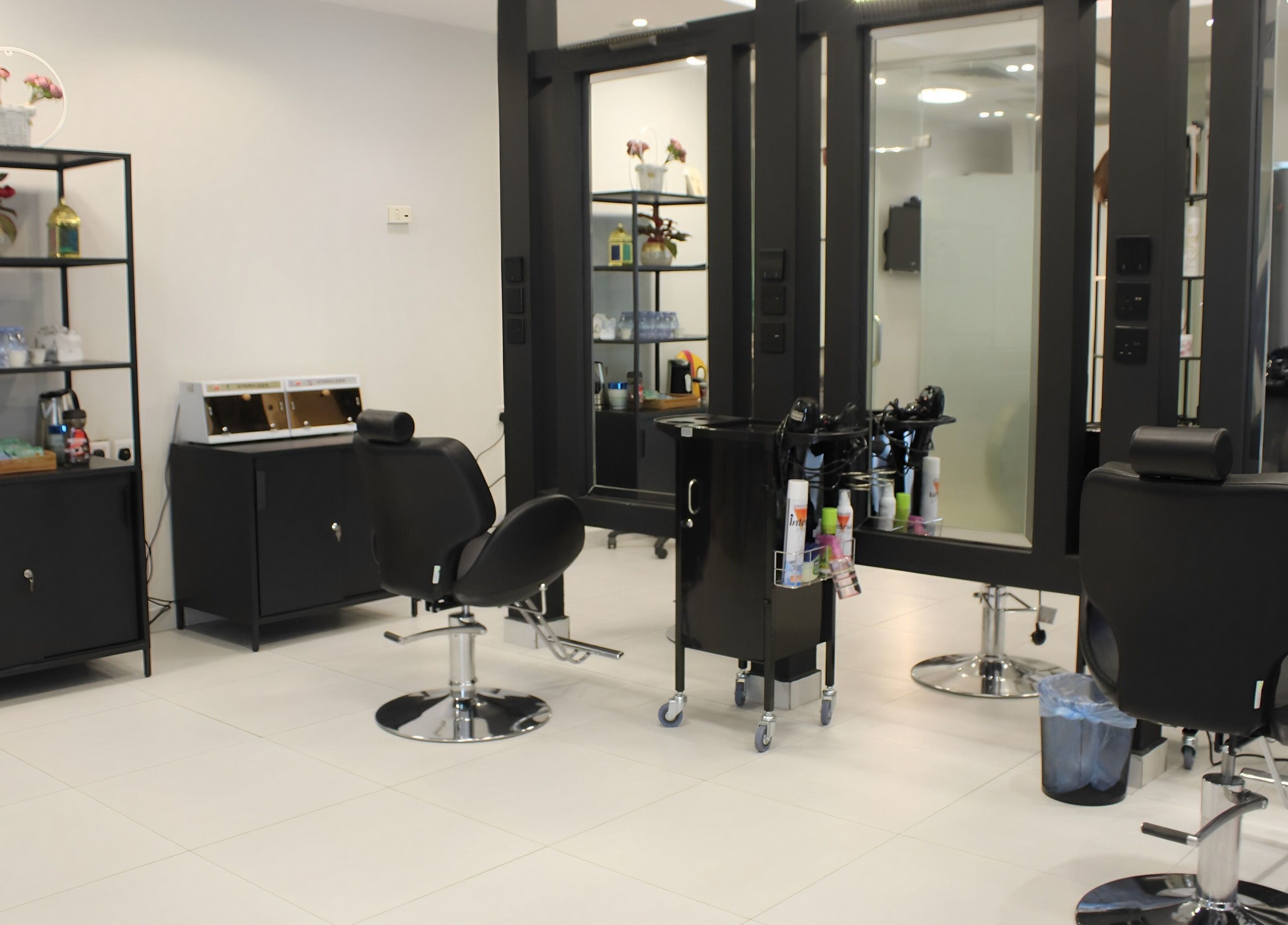 Modern interior of Aklel AlJamal Salon in Riyadh, Riyadh Province, SA showcasing sleek styling stations.