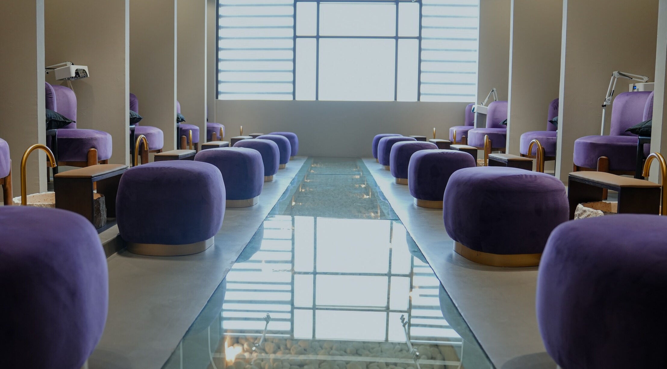 Luxurious pedicure seating at Trèfle Spa in Al Ain, Abu Dhabi, AE with plush purple chairs and serene ambiance.