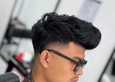 Trendy haircut by Otw Hairstudio, Jawa Barat, Jawa Barat, ID, showcasing a modern fade and textured top.