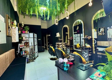 Luxurious interior of The Royalty Beauty Salon, Dubai, AE showcasing stylish decor and greenery.