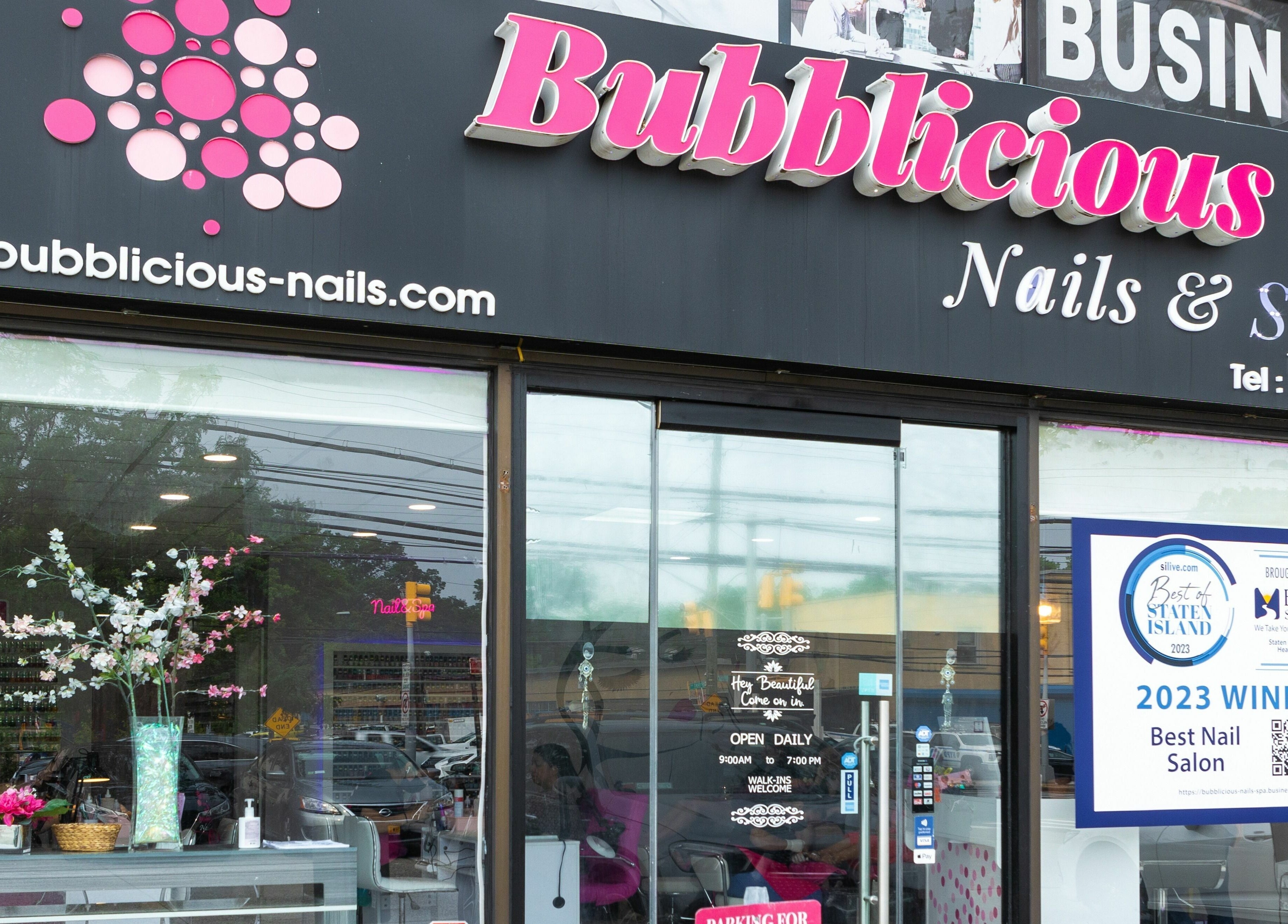 Exterior of Bubblicious Nails and Spa, New York, New York, US, featuring stylish signage and award display.