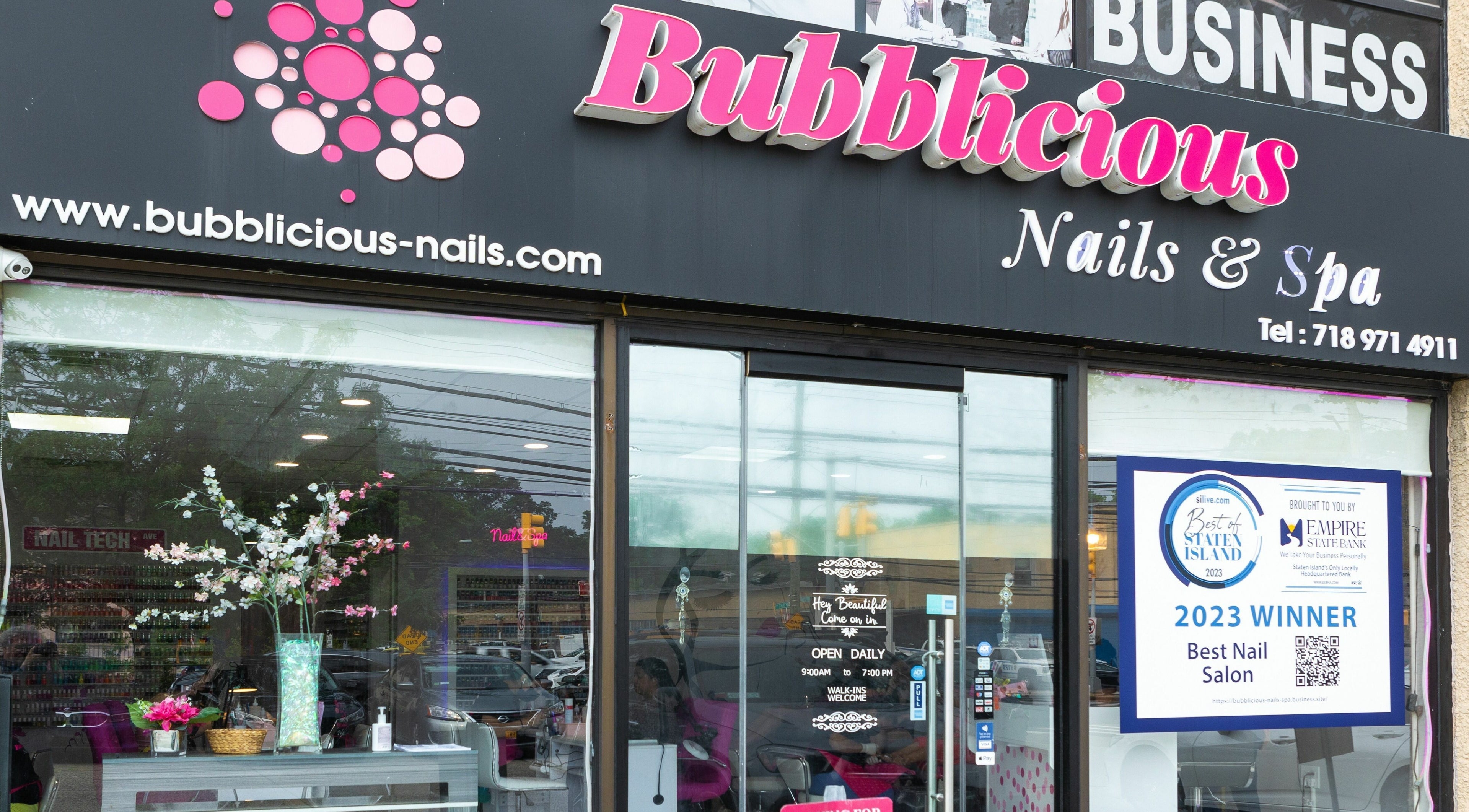 Exterior of Bubblicious Nails and Spa, New York, New York, US, featuring stylish signage and award display.