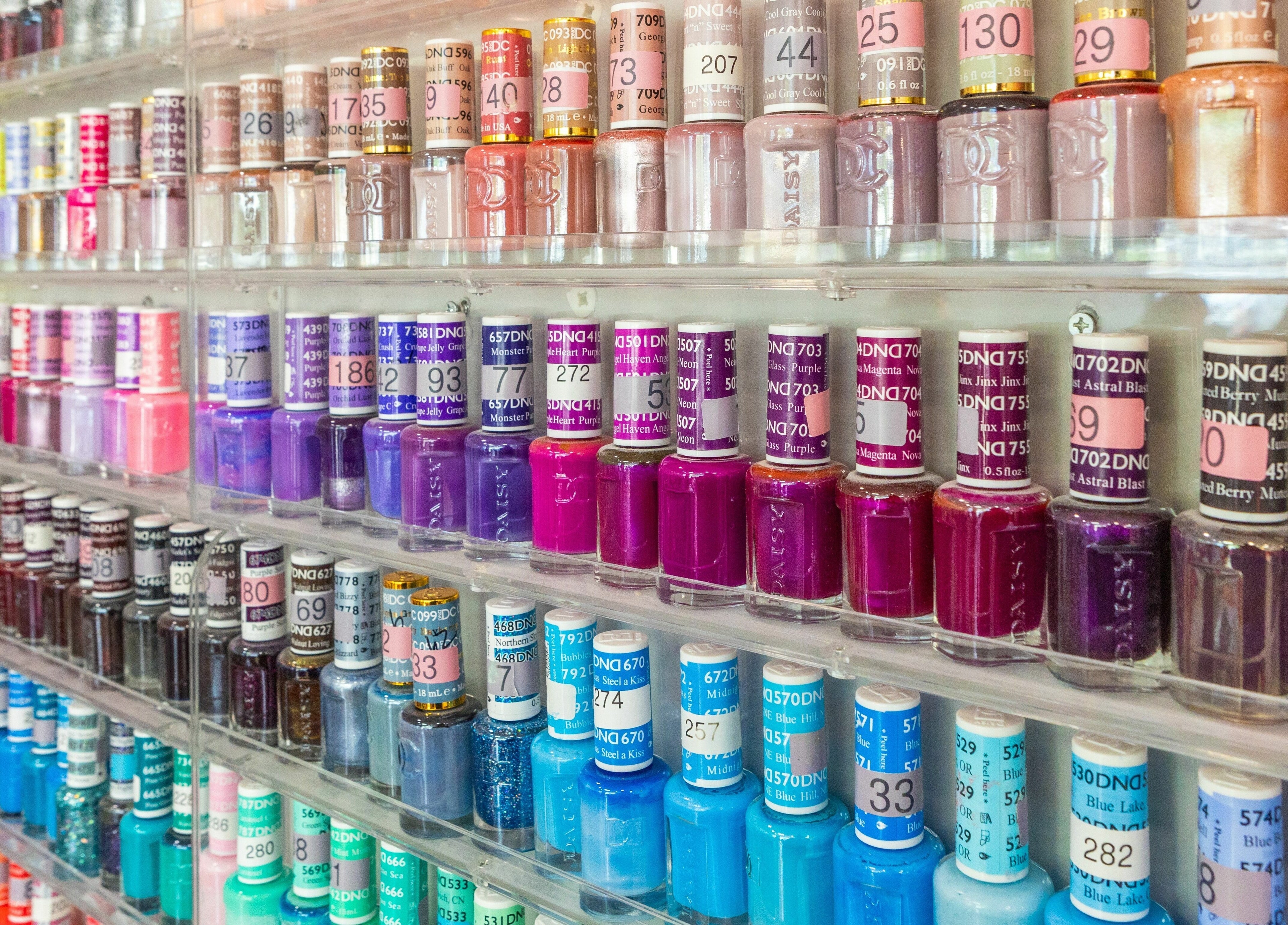 Colorful nail polish display at Bubblicious Nails and Spa, New York, New York, US. Perfect for beauty enthusiasts.