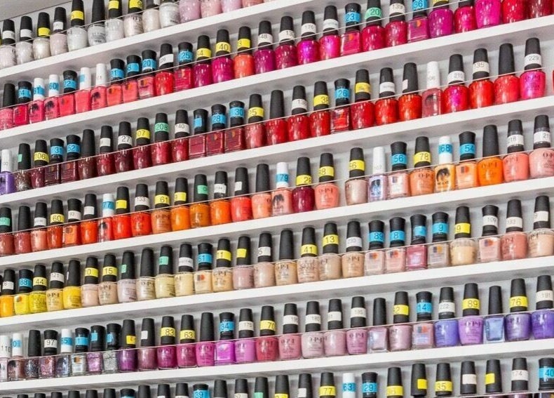 Variety of nail polish colors on shelves at Bubblicious Nails and Spa, New York, New York, US.