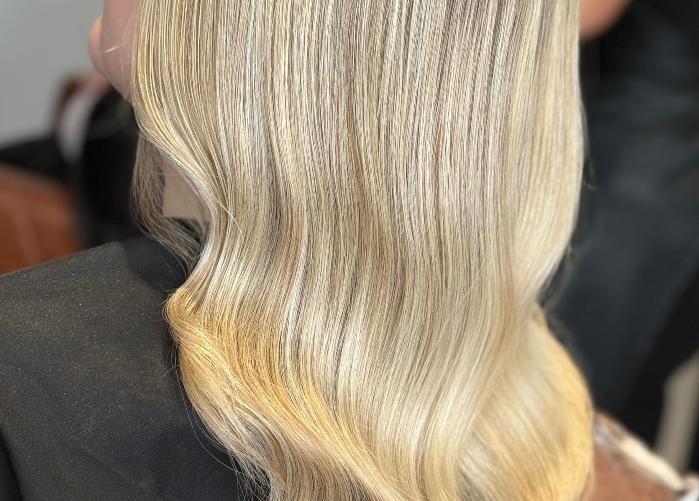 Blonde hair styled into smooth waves at Finesse academy of hair and holistics, Haydock, England, GB.
