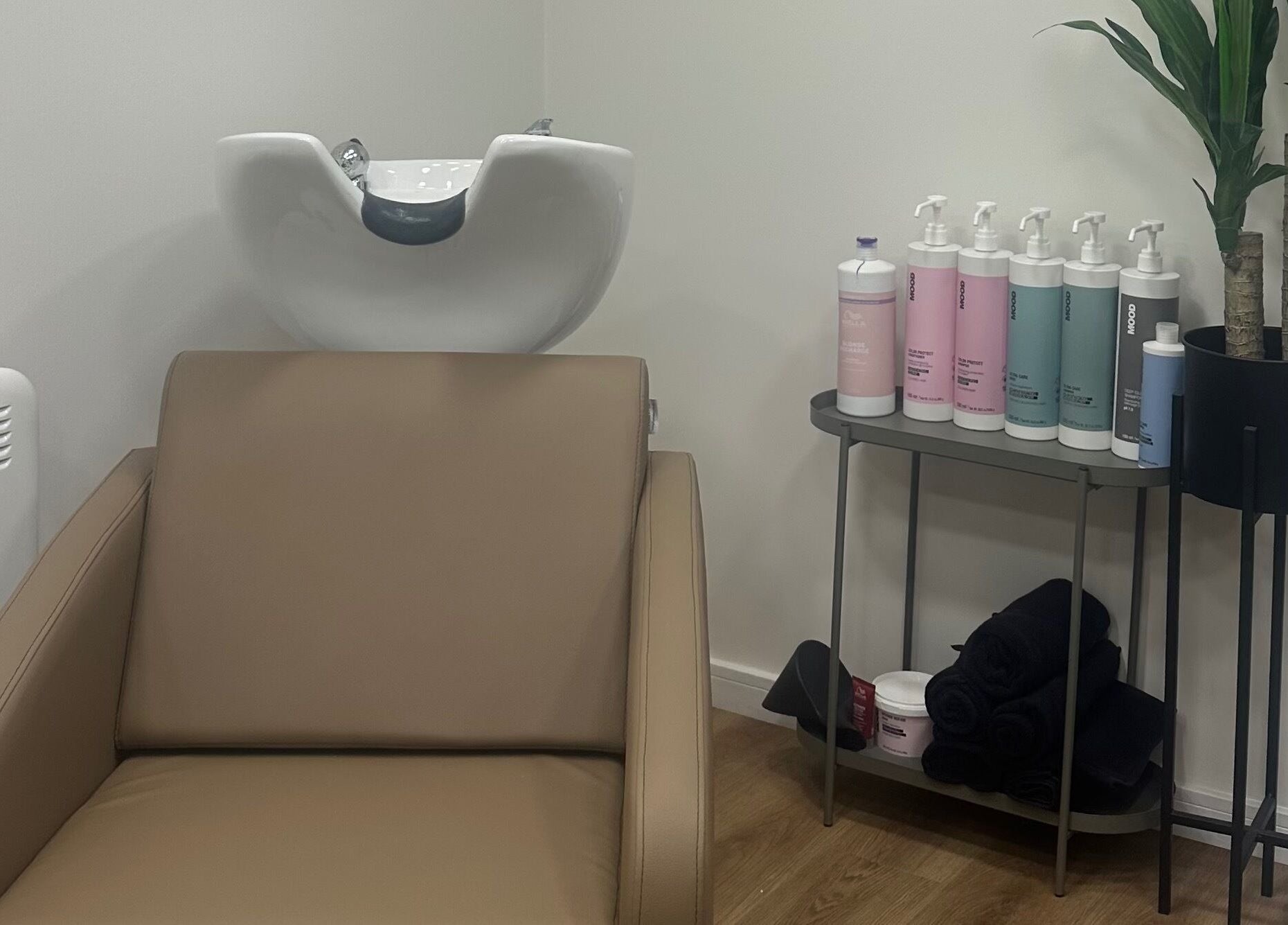 Elegant wash station at The View luxury home hair salon, Earley, England, GB, with products and modern decor.