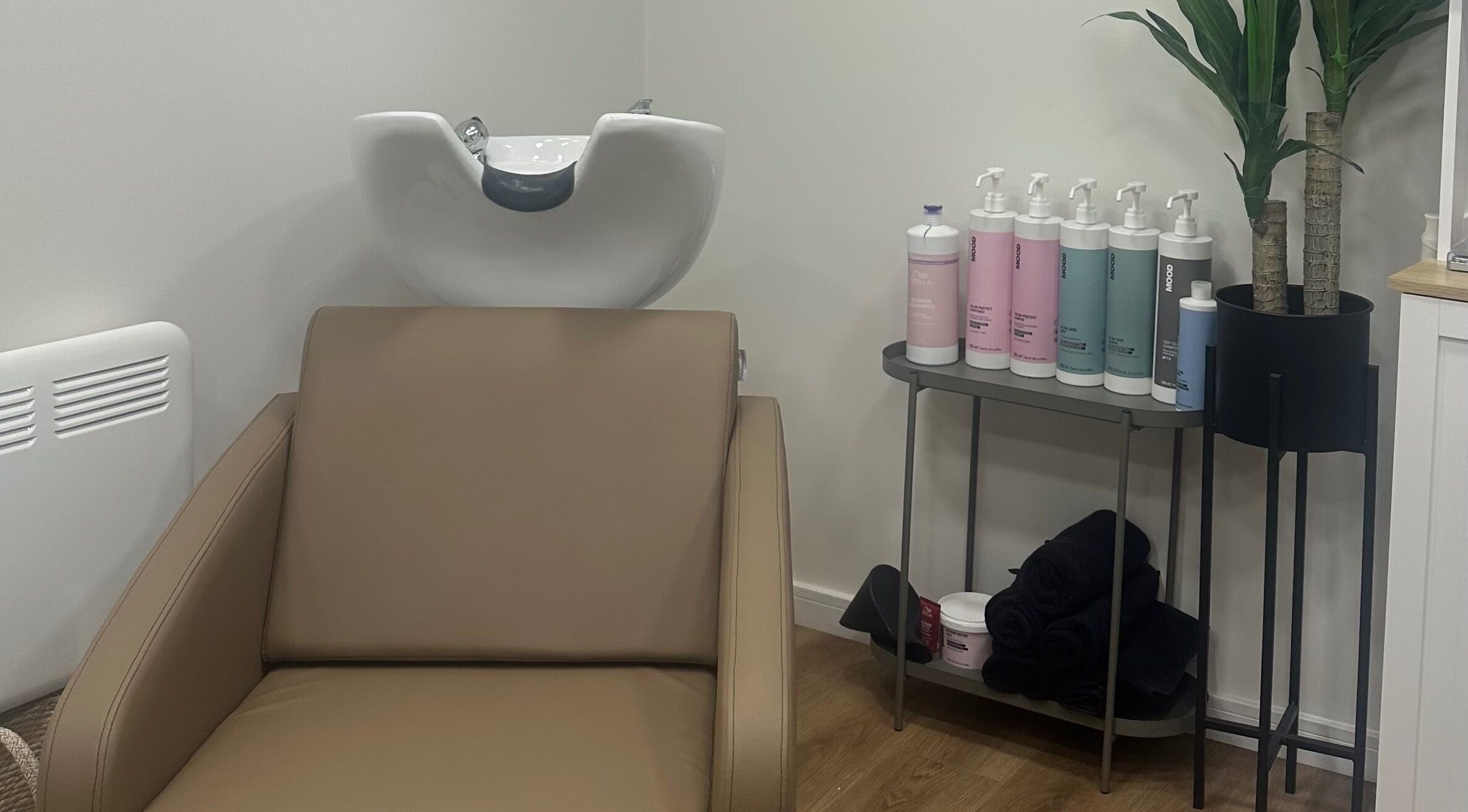 Elegant wash station at The View luxury home hair salon, Earley, England, GB, with products and modern decor.
