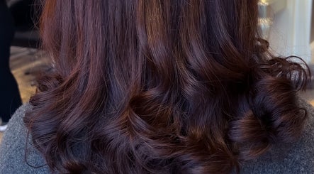 Luxurious brunette curls at Extensions With Kirsty in Trowbridge, England, GB showcasing stunning salon results.