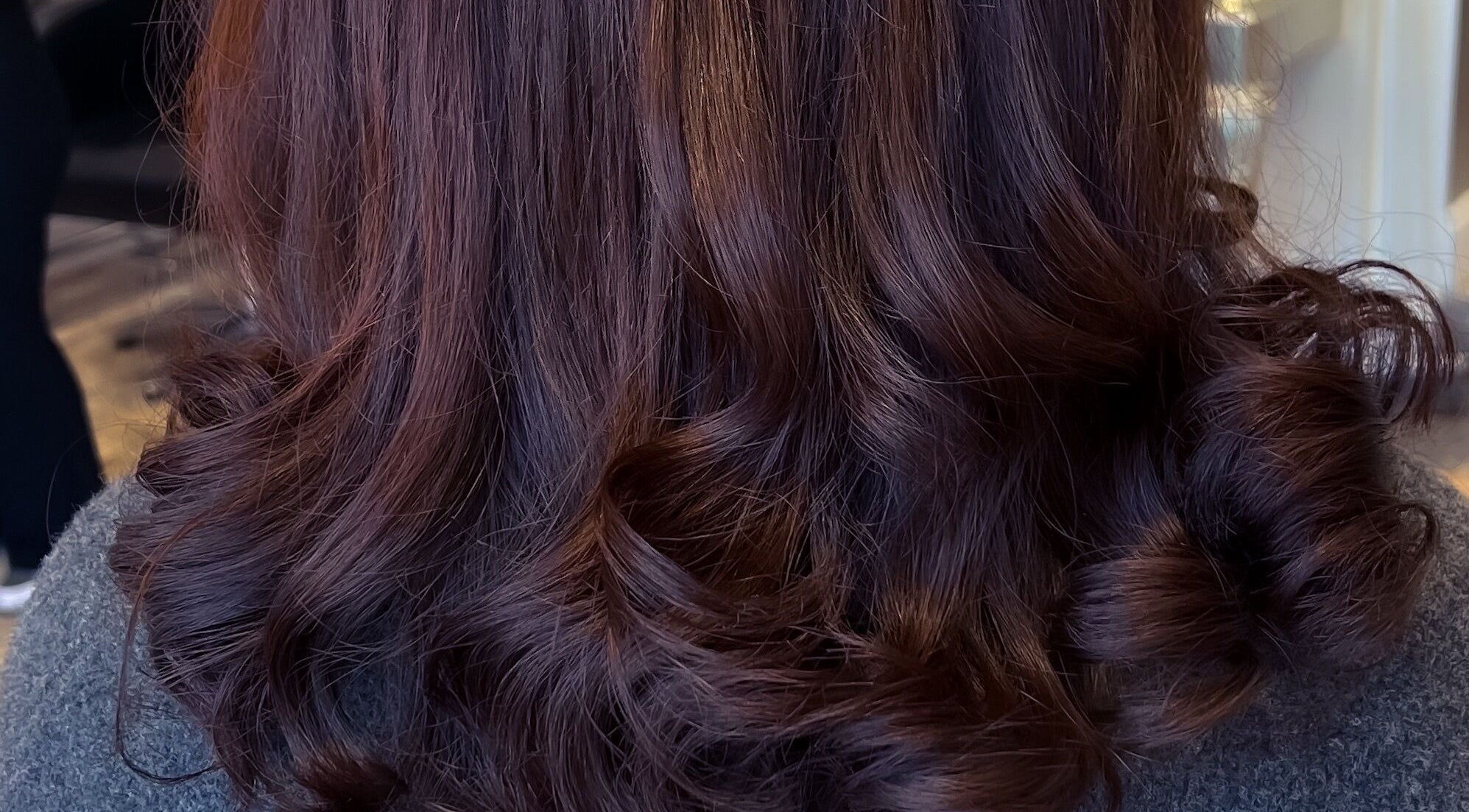 Luxurious brunette curls at Extensions With Kirsty in Trowbridge, England, GB showcasing stunning salon results.