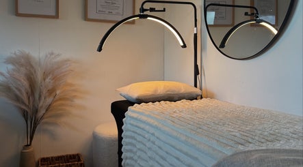 Peaceful spa room at By Naums, Tauranga, Bay Of Plenty Region, NZ, featuring elegant lighting and cozy decor.