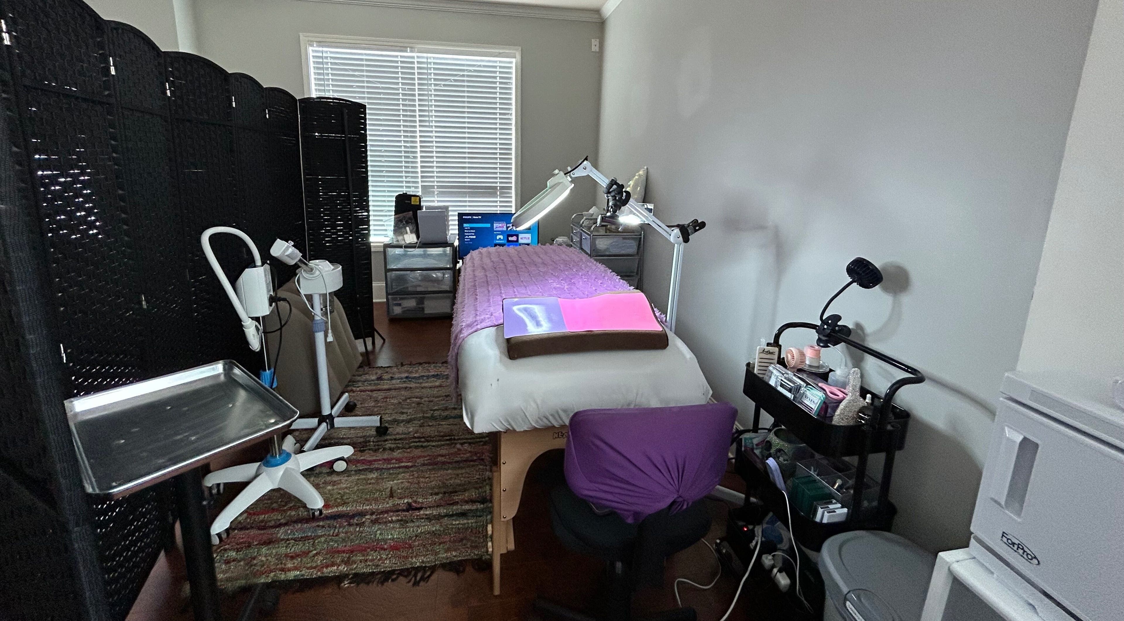 Treatment room at K. Marie Aesthetics Atlanta Bookings, South Fulton, Georgia, US with purple accents and equipment.