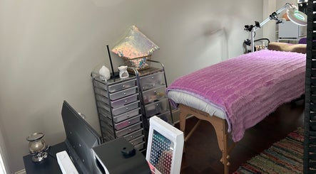 Cozy treatment room at K. Marie Aesthetics Atlanta Bookings, South Fulton, Georgia. Features a massage table and decor.