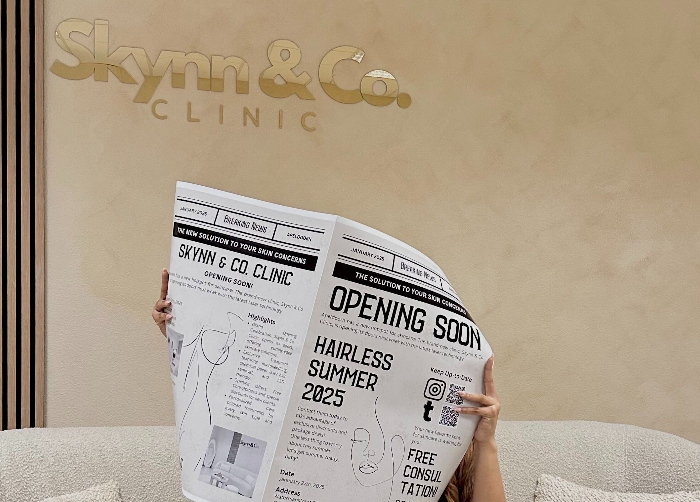 Person reading a newspaper with 'Skynn & Co. Clinic' logo at Apeldoorn, Gelderland, NL wall in the background.
