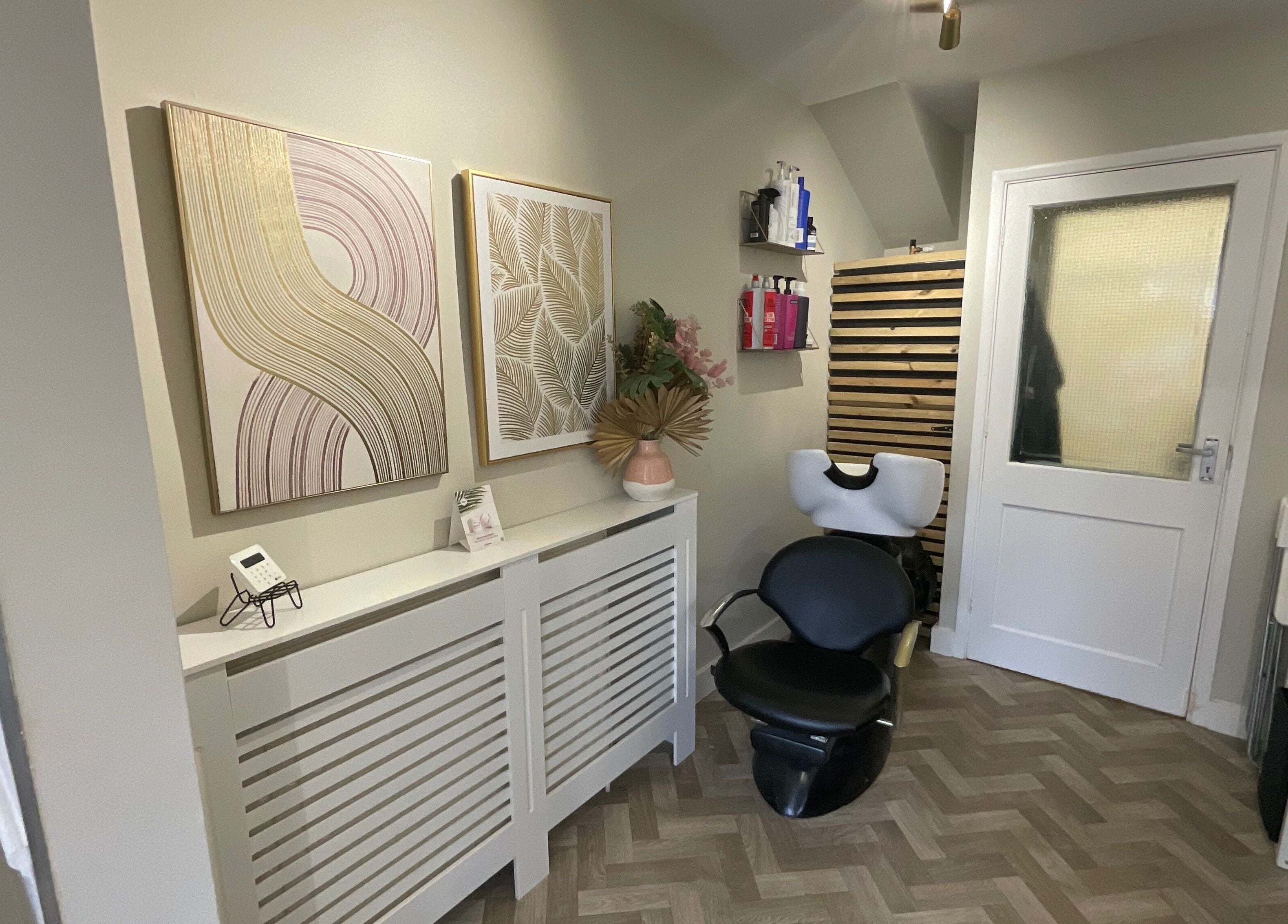 Stylish salon corner with art and chair at Glow Studio, Maidstone, England, GB.