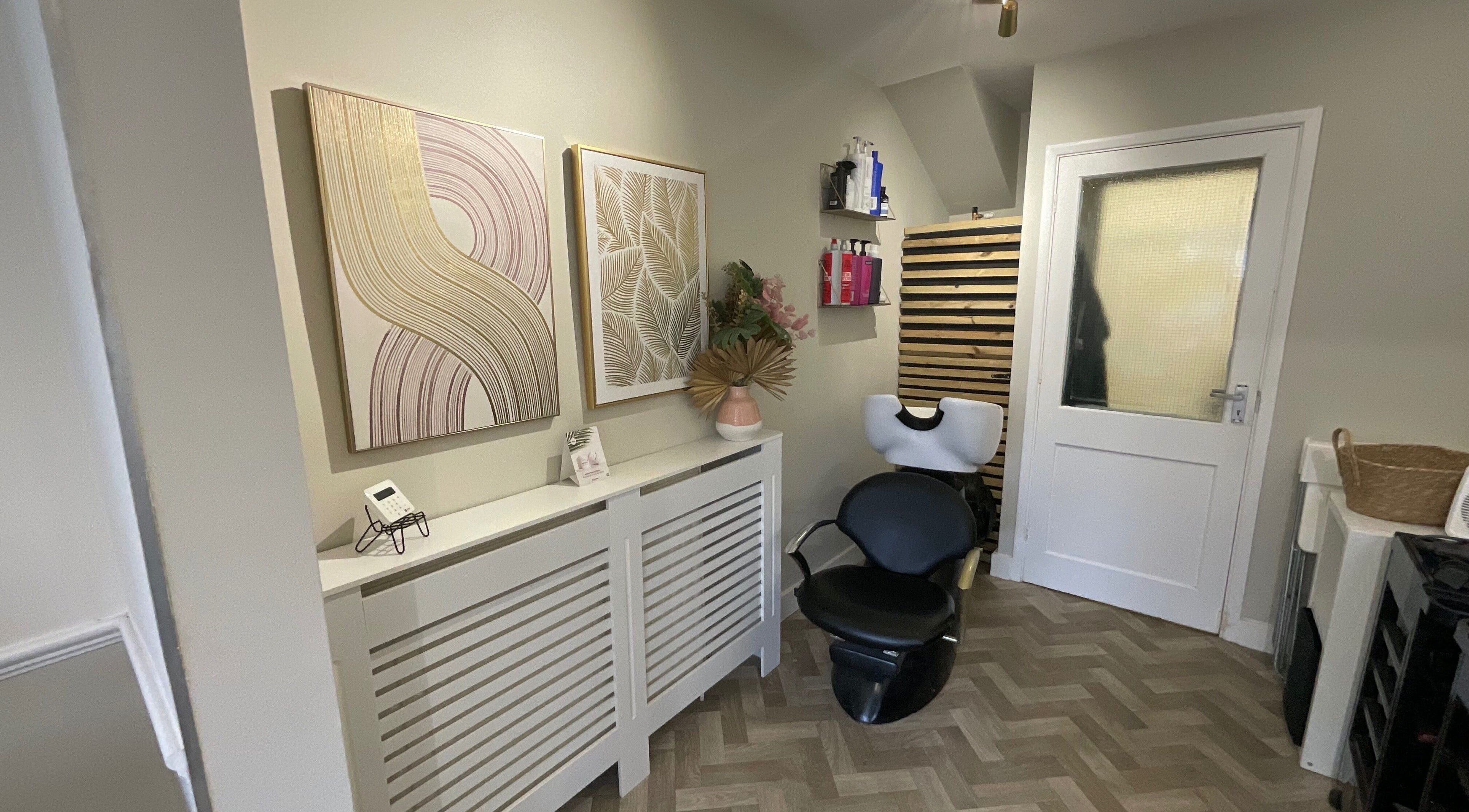 Stylish salon corner with art and chair at Glow Studio, Maidstone, England, GB.