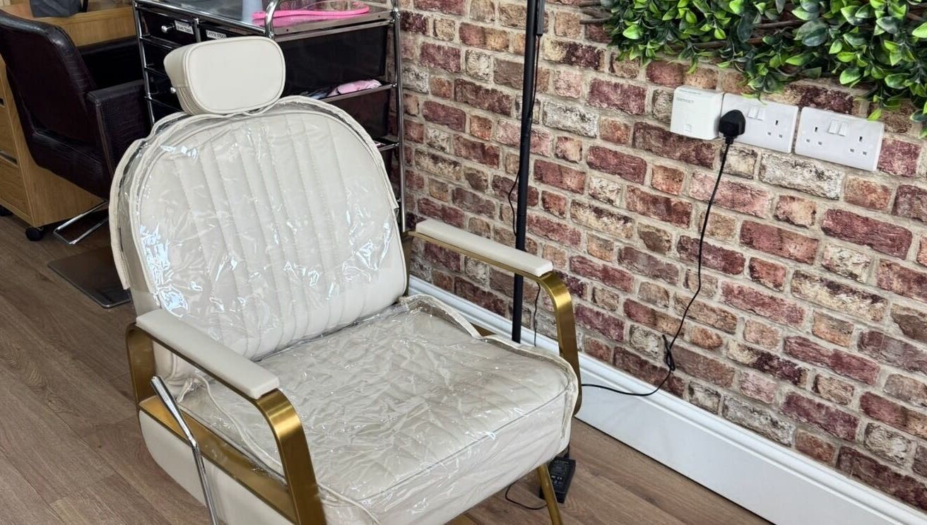 Elegant nail styling chair at Toni Michelle Nail Artist, Cleethorpes, England, GB, with a stylish brick wall.