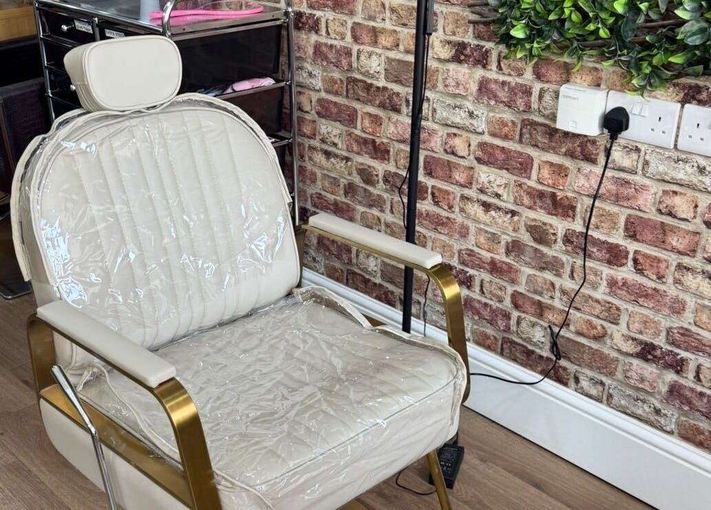 Elegant nail styling chair at Toni Michelle Nail Artist, Cleethorpes, England, GB, with a stylish brick wall.