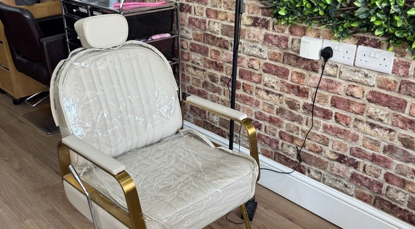 Elegant nail styling chair at Toni Michelle Nail Artist, Cleethorpes, England, GB, with a stylish brick wall.