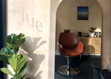 Inviting salon chair at Hue Hair and Beauty, Bristol, England, GB. Modern interior with natural lighting.