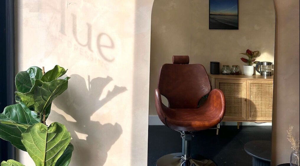 Inviting salon chair at Hue Hair and Beauty, Bristol, England, GB. Modern interior with natural lighting.