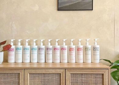Hair care products on wooden shelf at Hue Hair and Beauty in Bristol, England, GB showcasing elegant salon vibes.