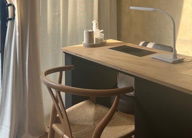 Cozy nail station at Hue Beauty, Bristol, England, GB, with elegant chair and ambient lighting.