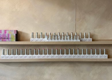 A vibrant nail polish display at Hue Beauty, Bristol, England, GB. Shelves with gel bottles in various colors.