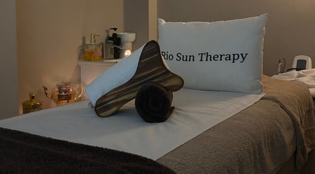 Relaxing massage bed setup at Rio Sun Massage Therapy, London, England, GB, with cozy decor.