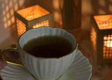 A serene cup of tea with warm candlelight at Rio Sun Massage Therapy, London, England, GB.