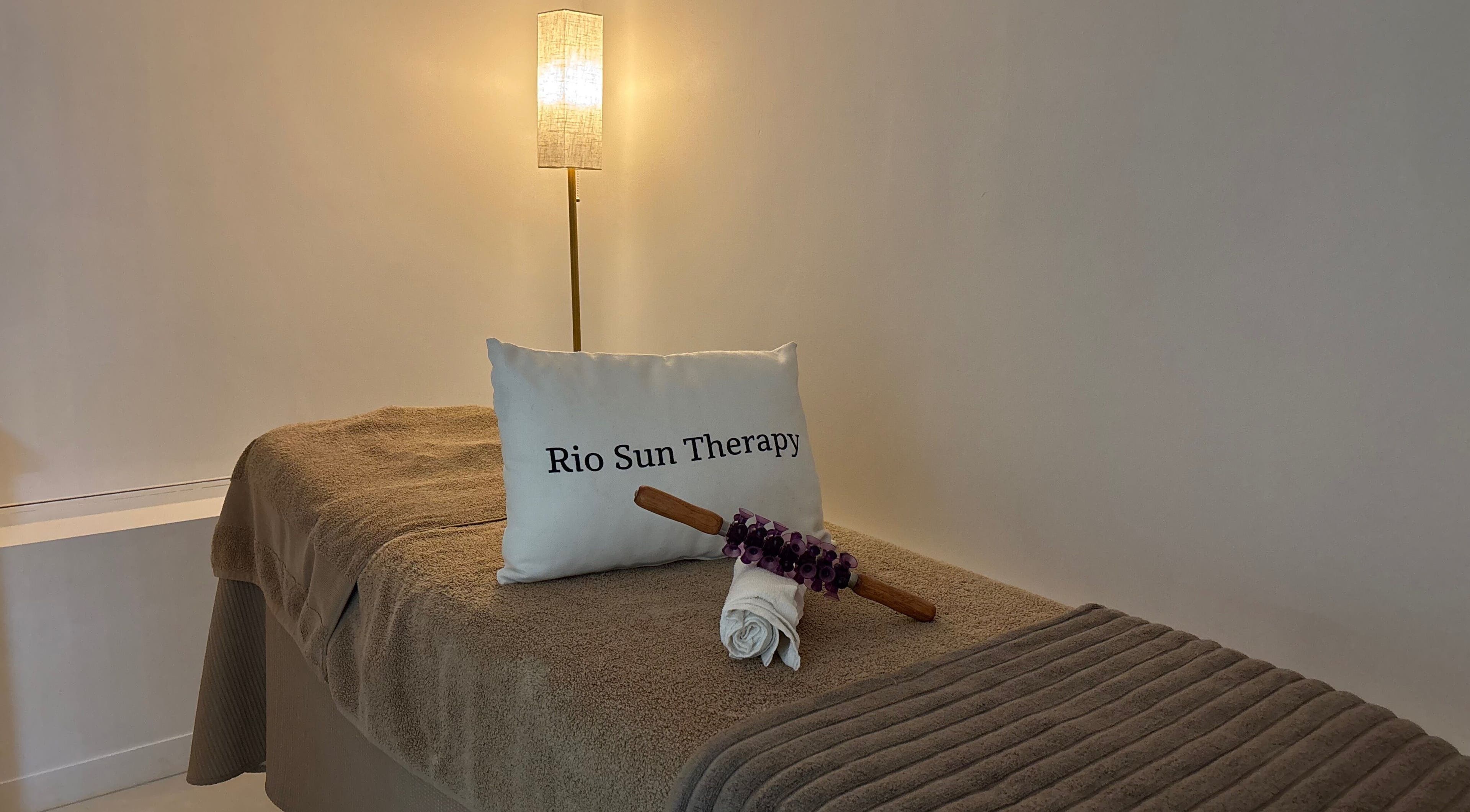 Relaxing massage room at Rio Sun Massage Therapy, London, England, GB with soft lighting and cozy decor.