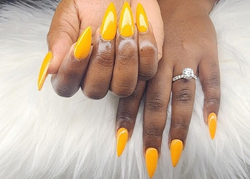 Bright yellow manicured nails with ring at Toyazz Touch Of Beauty, Ocho Rios, St. Ann Parish, JM.