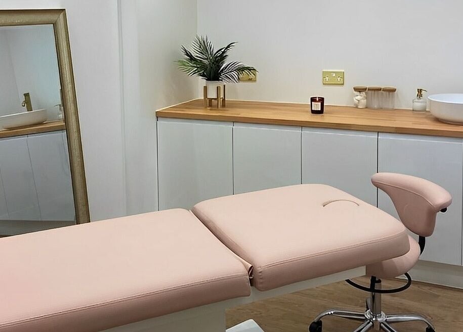 Elegant treatment room at Aesthetics By Rachel Haq in Oldham, England, GB showcasing a plush bed and stylish decor.