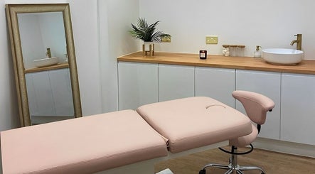 Elegant treatment room at Aesthetics By Rachel Haq in Oldham, England, GB showcasing a plush bed and stylish decor.