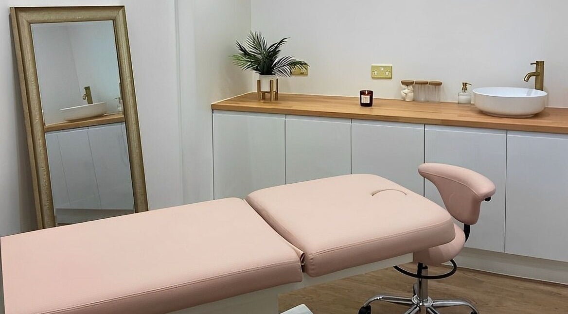 Elegant treatment room at Aesthetics By Rachel Haq in Oldham, England, GB showcasing a plush bed and stylish decor.