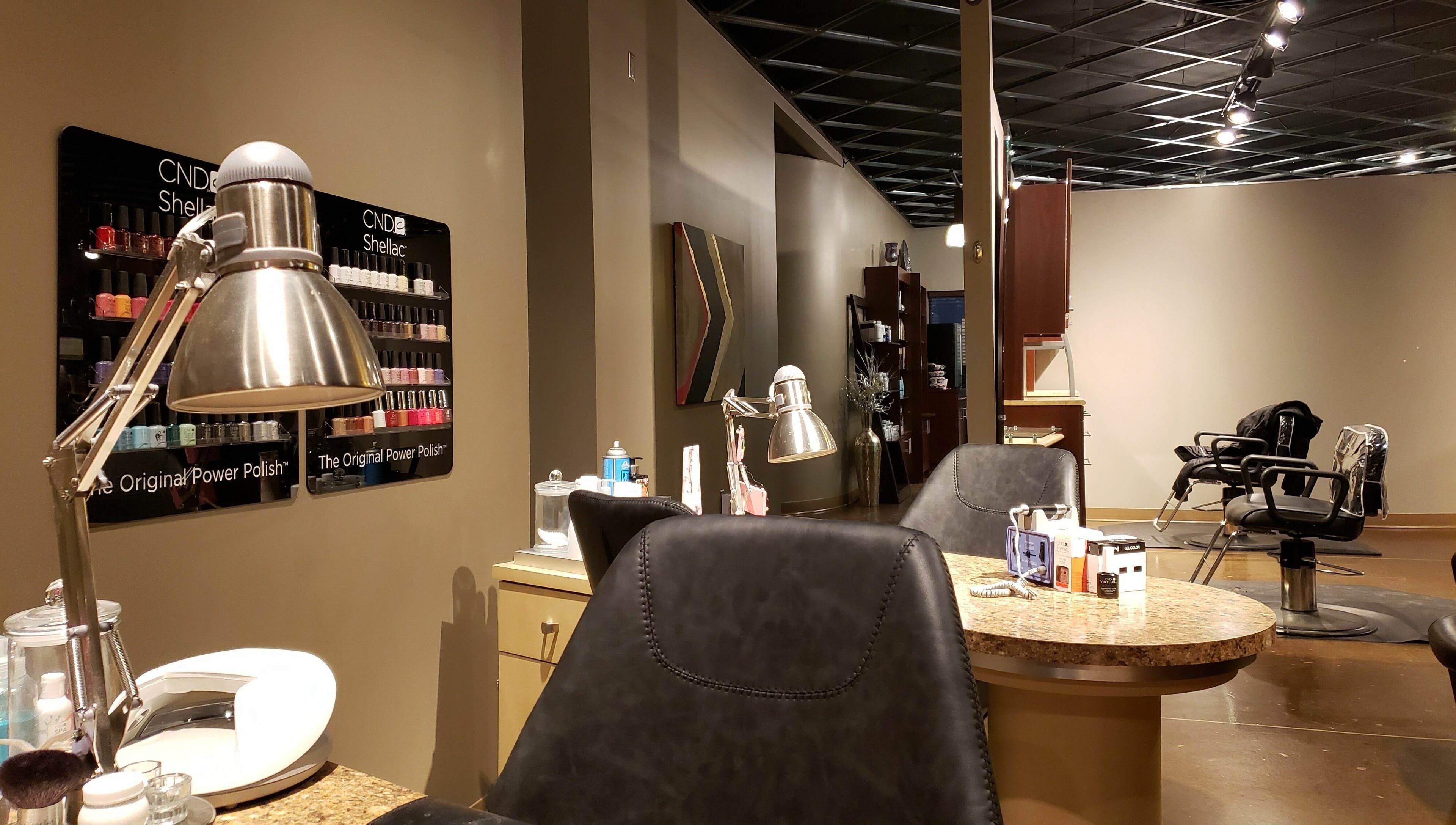 Modern salon interior at Indulge Salon and Spa in Grand Island, Nebraska, US featuring nail and hair stations.