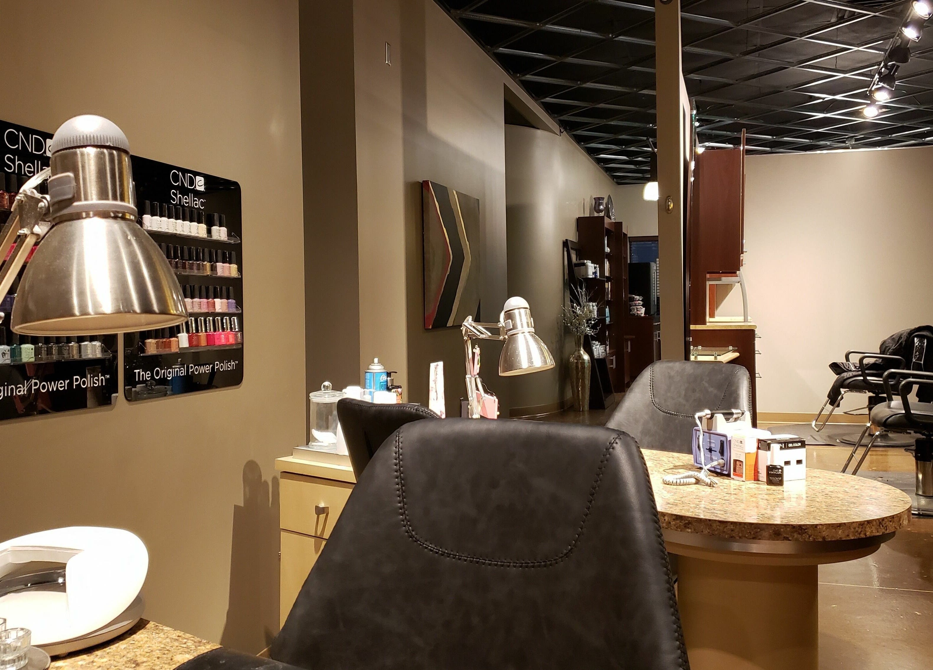 Modern salon interior at Indulge Salon and Spa in Grand Island, Nebraska, US featuring nail and hair stations.