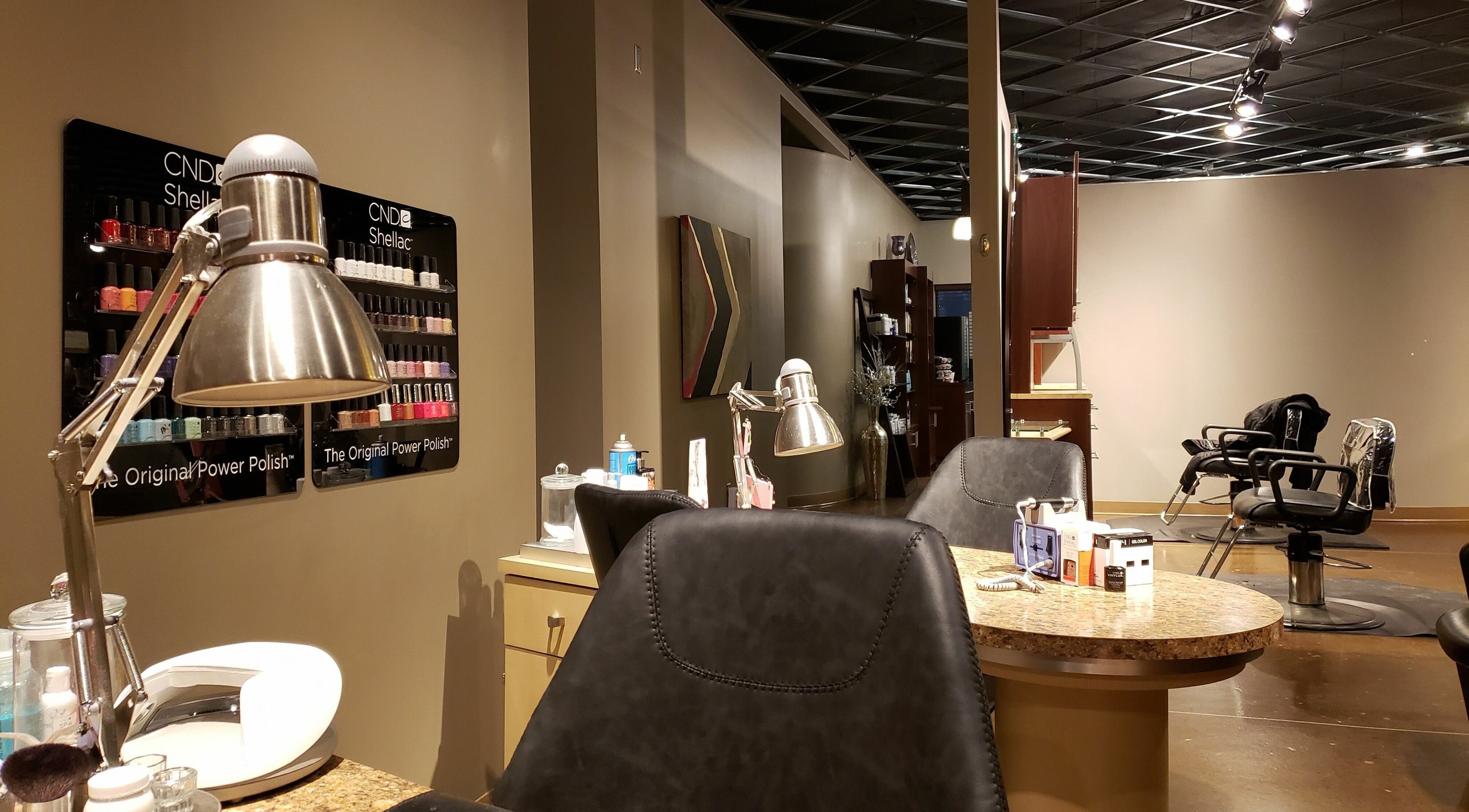Modern salon interior at Indulge Salon and Spa in Grand Island, Nebraska, US featuring nail and hair stations.