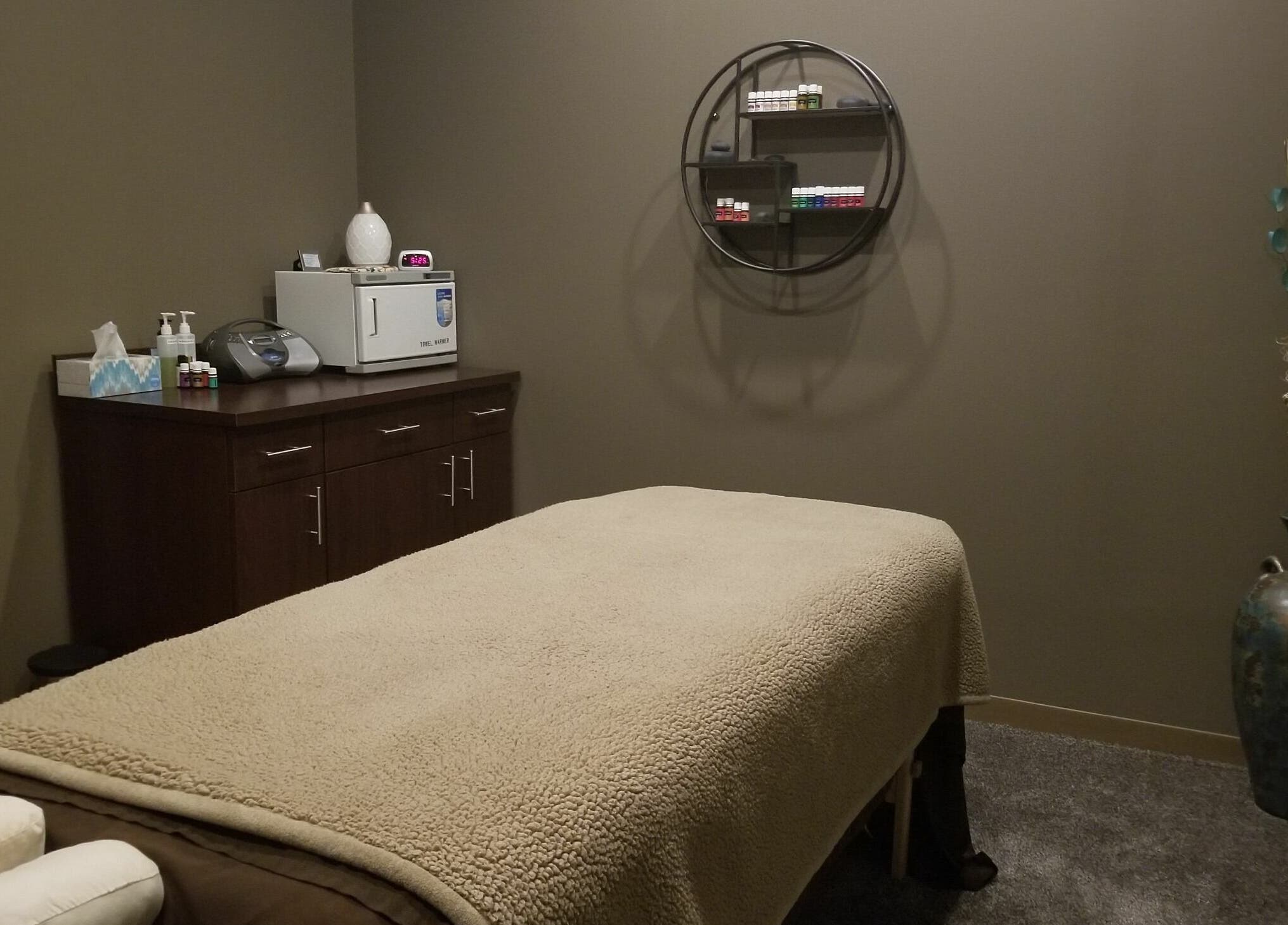 Relaxing treatment room at Indulge Salon and Spa, Grand Island, Nebraska, US, with a massage table and soothing decor.